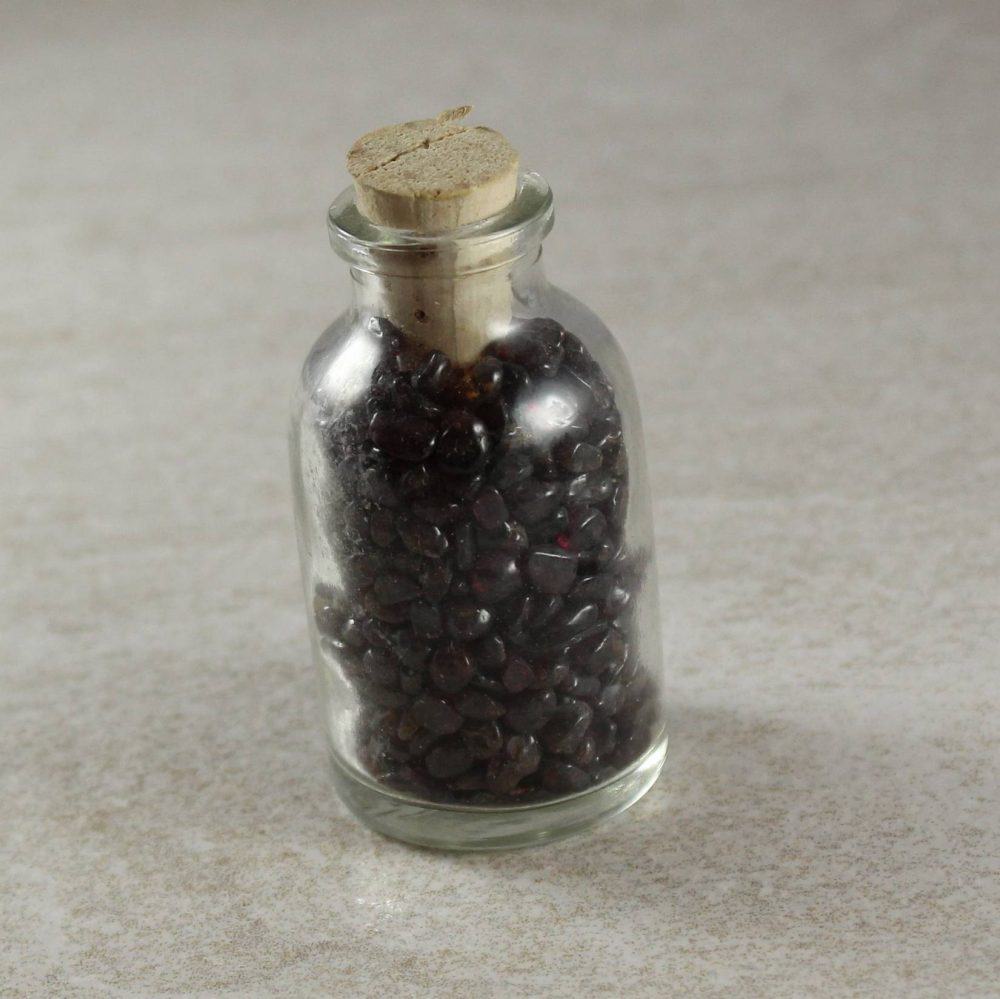 garnet crystal chips in a bottle (almandine)