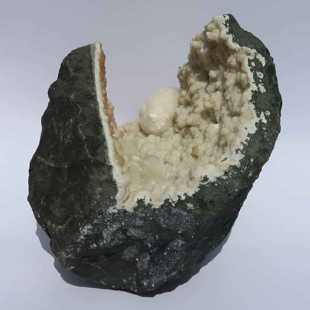 okenite gyrolite and calcite in quartz geode from india 11