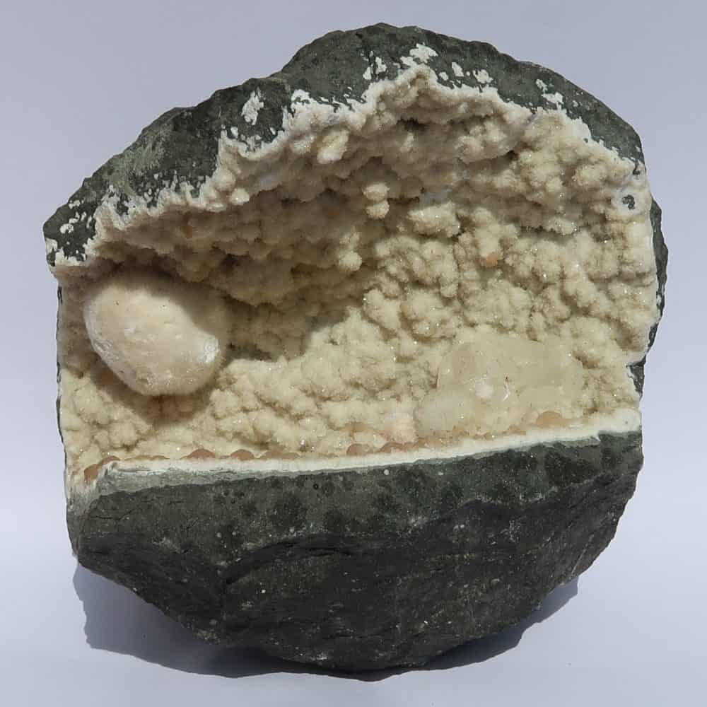 okenite gyrolite and calcite in quartz geode from india 12